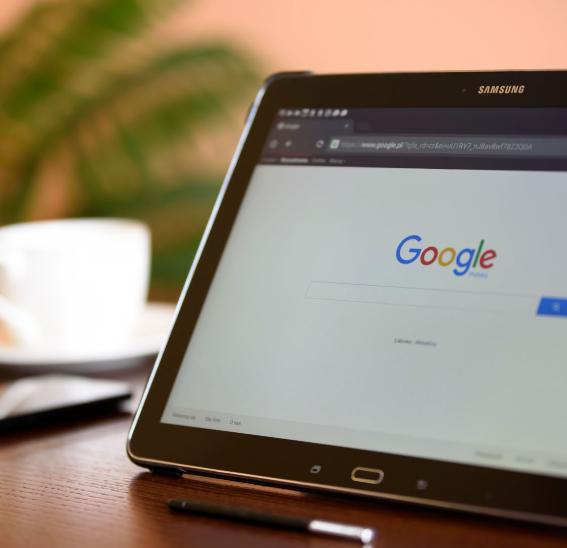 Samsung tablet on desk showing Google homepage, perfect for technology-related content.
